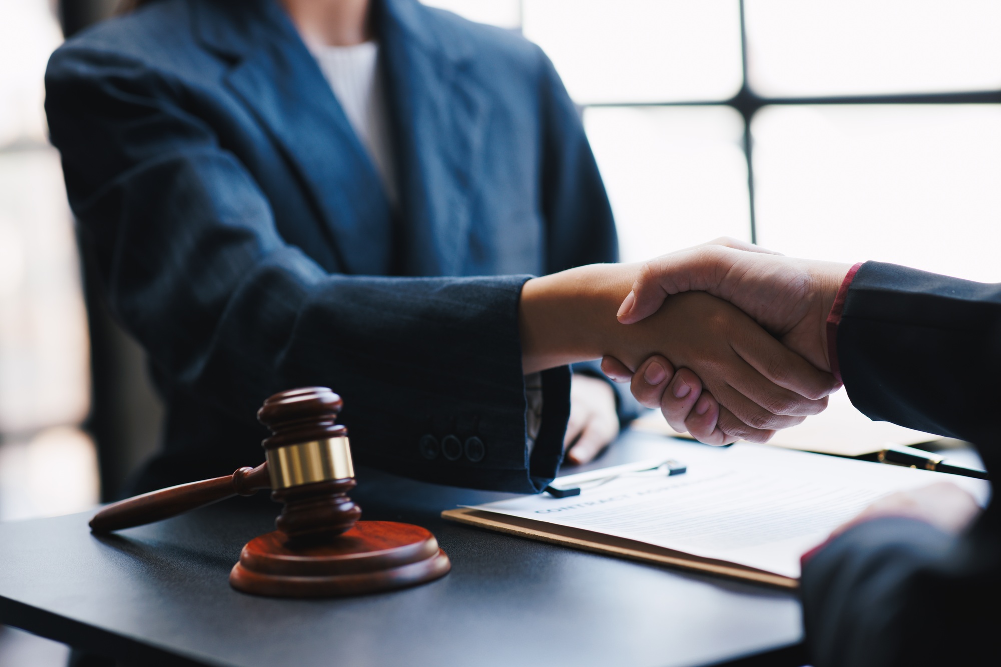 Lawyers shake hands with business people to seal a deal with partner lawyers. or a lawyer discussing